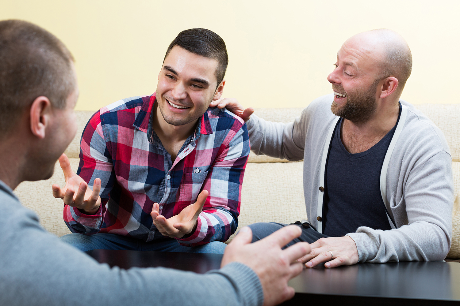 A small group of men talking and laughing