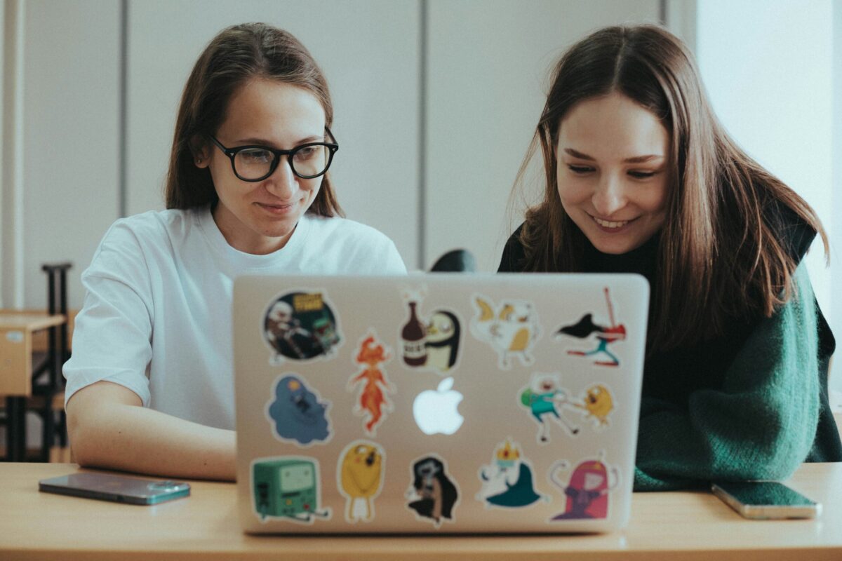 Two women looking at a laptop